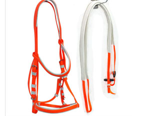 Neon orange PVC bridles and reins with soft padding on nose